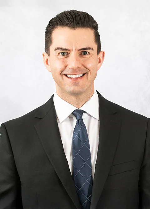 Dr. Tony Rhodes wearing a suit and smiling for the camera during a professional photoshoot