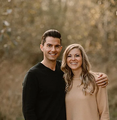 Chiropractor Tigard OR Tony Rhodes Dr. Tony Rhodes standing with his arm around his wife in the woods during a photoshoot