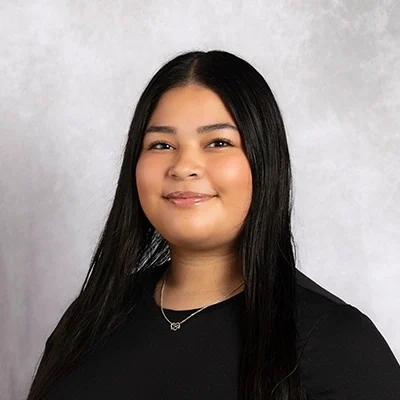Dayana smiling in a black shirt.