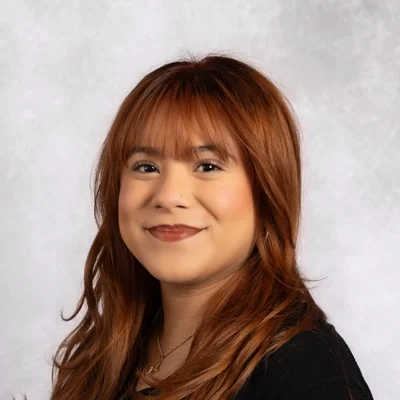 Samy smiling in black shirt.